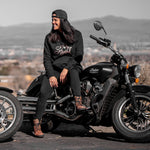 Women sitting on a motorcycle wearing a black hoodie with Lady Legend on it